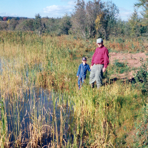 Charles and Wilhelmena’s grandkids are poised to become the seventh generation to continue the family tradition of agriculture. Here, an older photo shows Charles and his grandson, Joshua Hayden, visiting one of the many wetlands on their farm, one that is being protected by the Murphy’s ALUS projects. Through ALUS, they have established wider buffer zones around their wetlands, as well as the shoreline. Photo: Charles Murphy