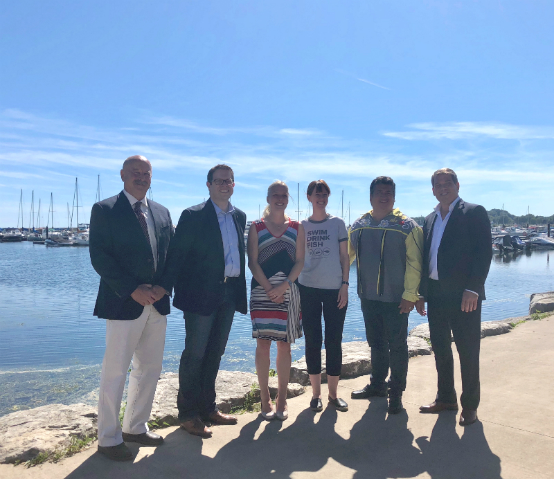 In Port Colborne on July 19, 2018, Environment and Climate Change Canada announced a $600,000 grant to ALUS Canada to help improve Lake Erie water quality. From L to R: Bryan Gilvesy, CEO of ALUS Canada; MP Chris Bittle; the Hon. Catherine McKenna, Minister of Environment and Climate Change Canada; Krystyn Tully of Swim Drink Fish Canada; Chief Stacey LaForme of Mississaugas of the New Credit; MP Vance Badawey.