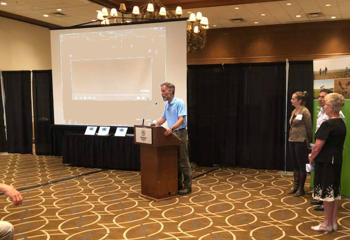 “ALUS participants produce cleaner air, cleaner water, more biodiversity and other ecosystem services, which have economic value to the rest of us,” said Ken Lewis, the ALUS Red Deer County Program Coordinator, shown here accepting the PAMZ Blue Skies Award at the Red Deer Sheraton on June 6, 2018. 