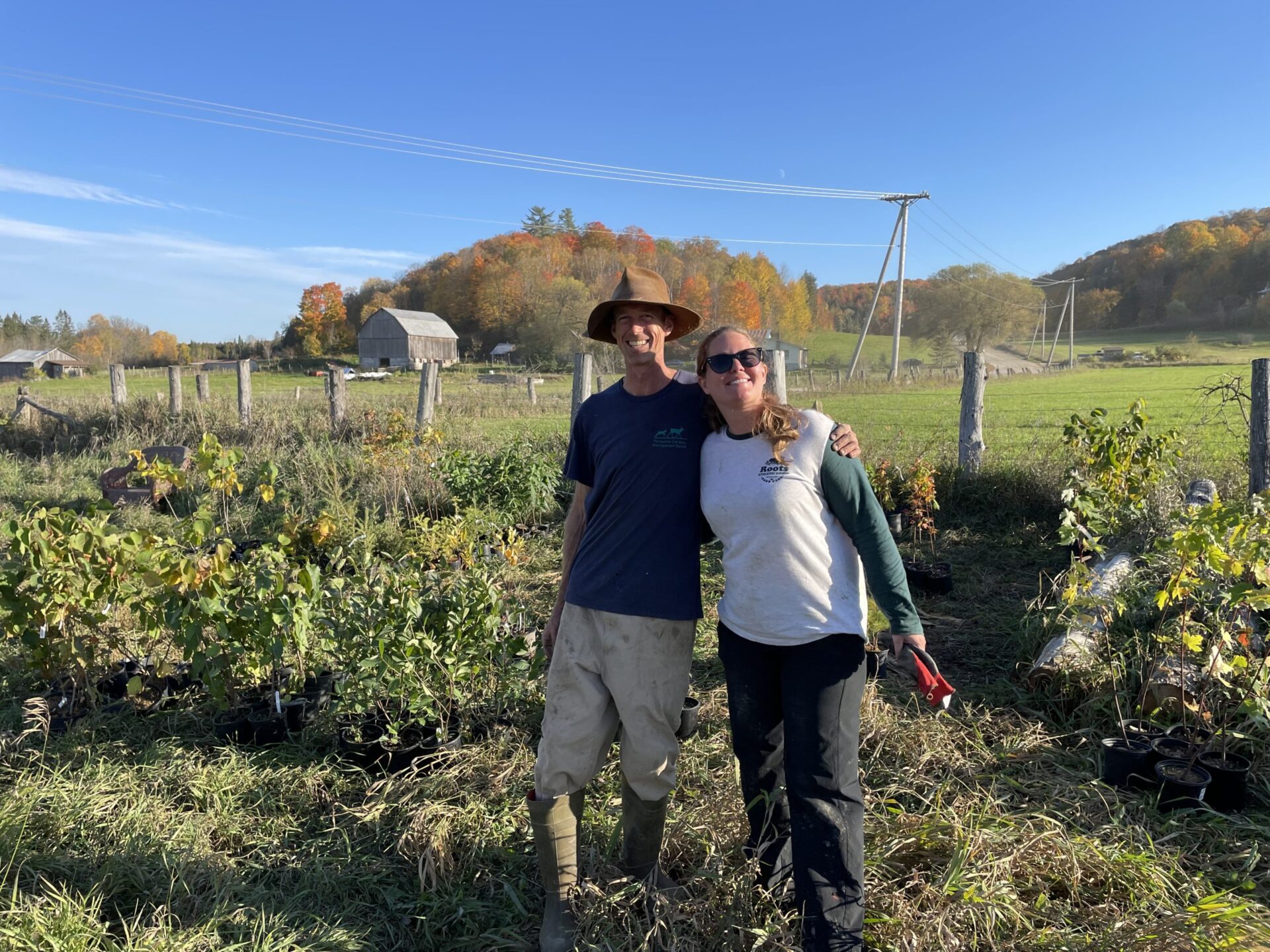 Alyssa Cousineau (right) helps Ian McClatchy with planting trees and shrubs on his farm in Outaouais, Quebec IMG_2276