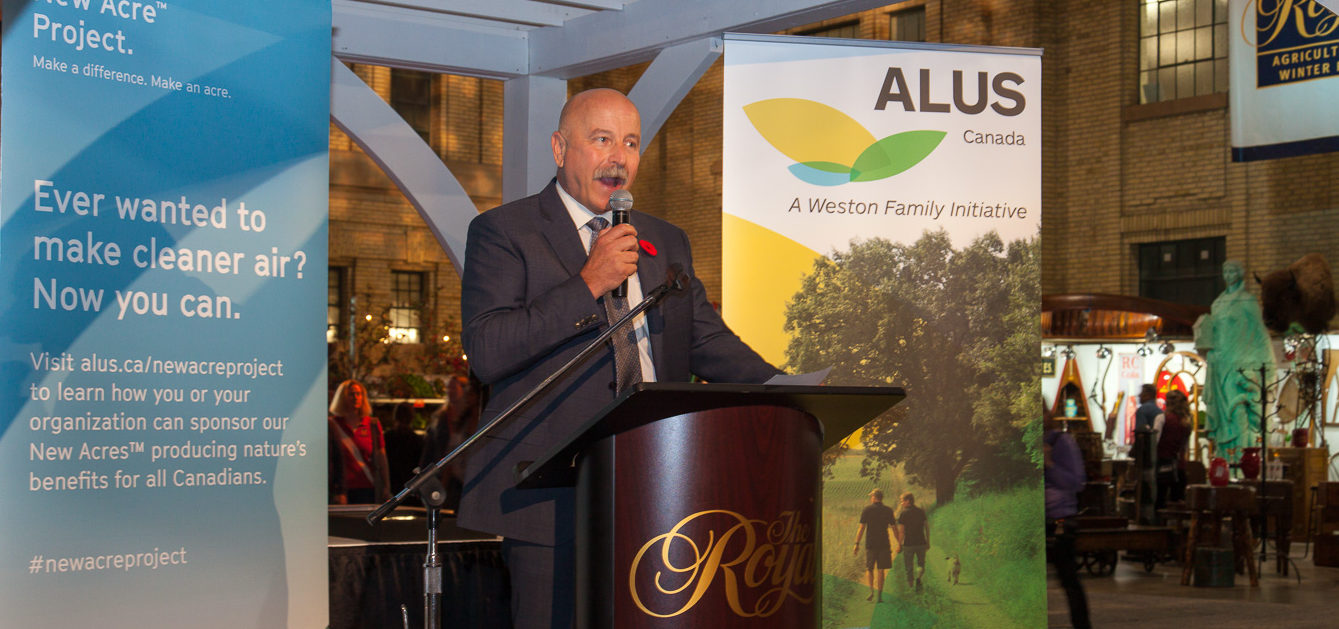 ALUS CEO Bryan Gilvesy stands in front of podium at official ALUS re-launch.