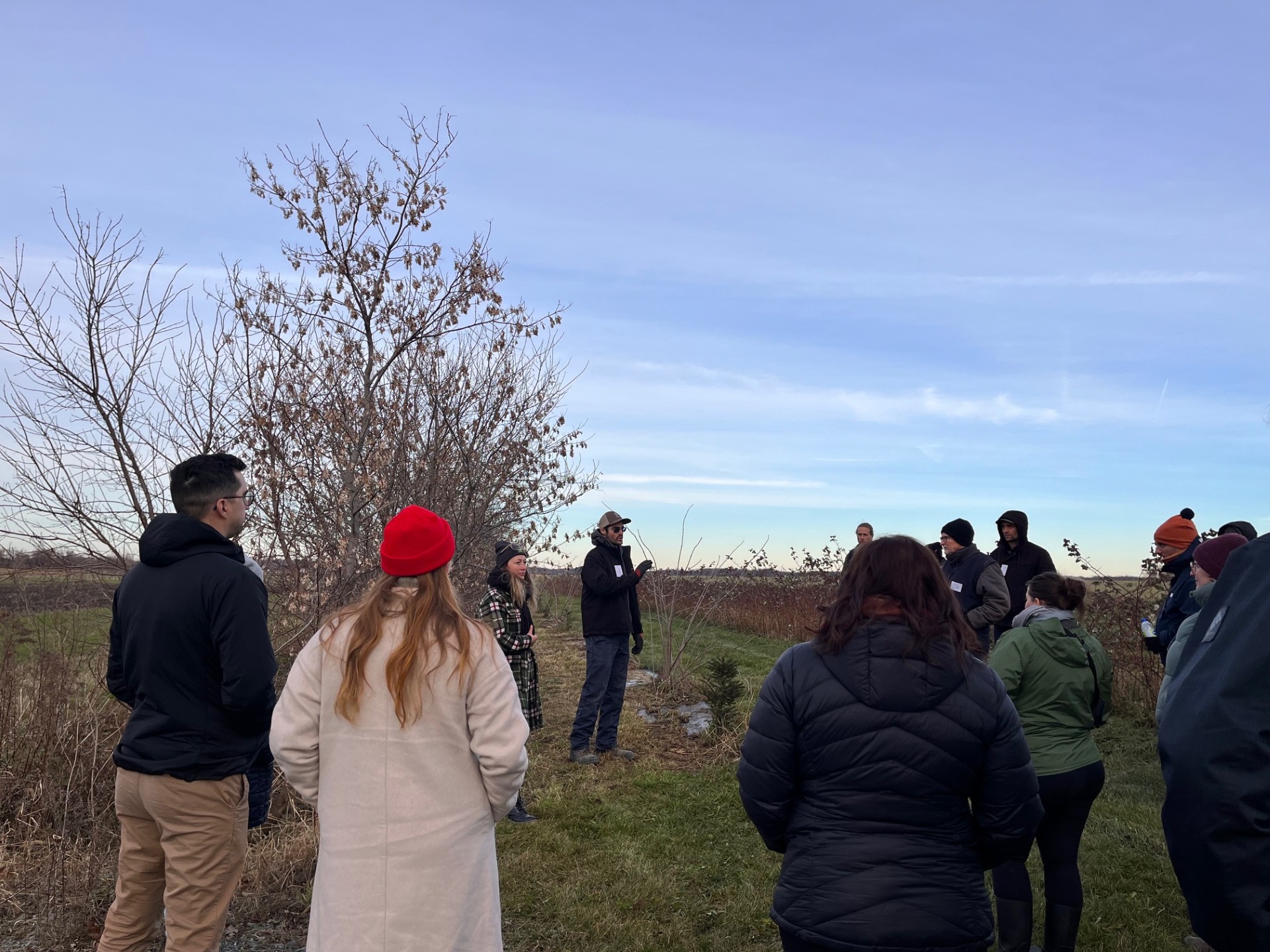 People standing in the field at Ferme Briho-Bel.