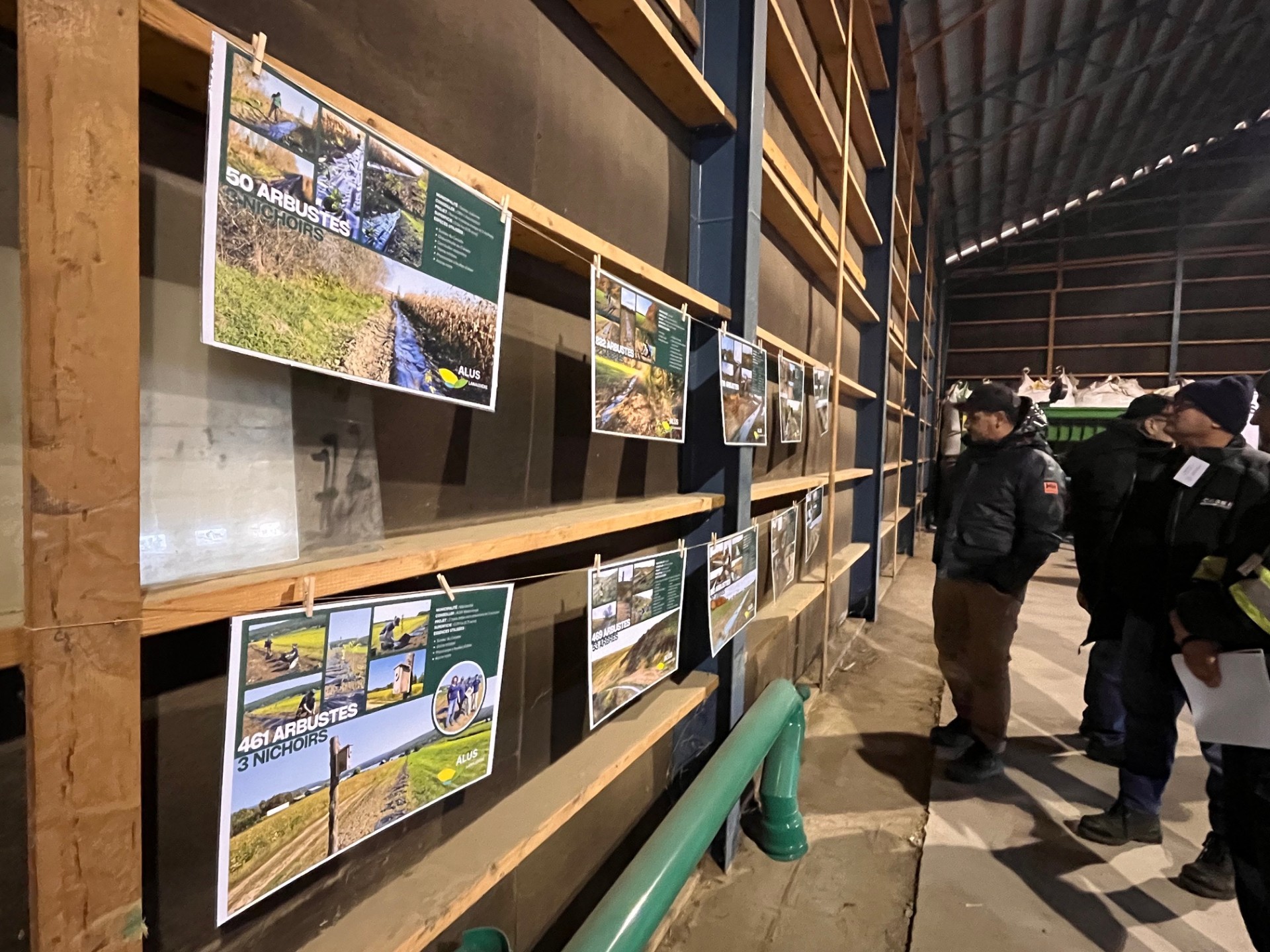 People looking at posters with information about ALUS at Ferme Briho-Bel in Lanaudière.